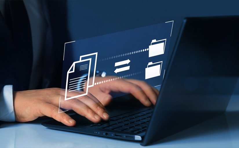 A person typing on a laptop with digital icons of folders and a document, representing data backup and recovery or file sharing, displayed above the keyboard.