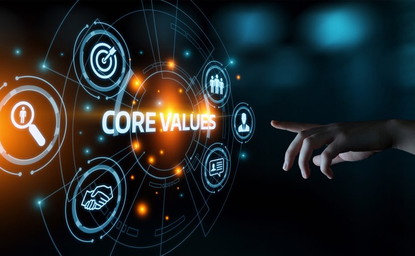 A hand points toward a glowing digital interface displaying the words CORE VALUES, highlighting GoodSuite’s commitment to goals, teamwork, trust, and search, all set against a dark, futuristic background.