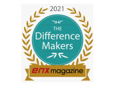 A teal and gold badge reads 2021 Difference Makers with a laurel wreath design, celebrating blockbuster performances. Below is a gold banner with enx magazine written on it, recognizing leaders in office equipment.