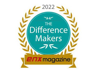 A teal and gold badge reading 2022 The Difference Makers honors industry 2022 office equipment leaders, surrounded by a gold laurel wreath. Below, a gold ribbon displays enx magazine in black and red text.